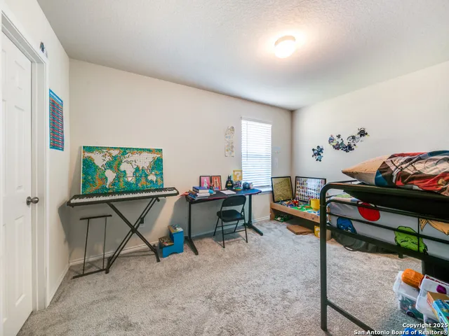 a living room with furniture a flat screen tv and a window