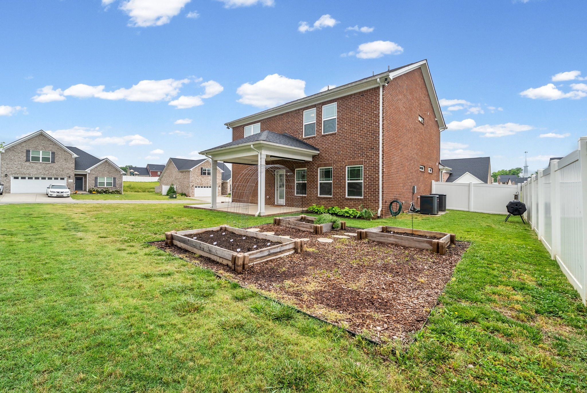 719 Reflections Lane Pleasant View, TN 37146 - Photo 37 of 46 a front view of a house with a yard table and chairs