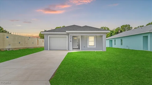a front view of a house with a garden and yard