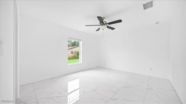 a view of room with window and a ceiling fan