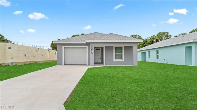 a front view of a house with a garden and yard