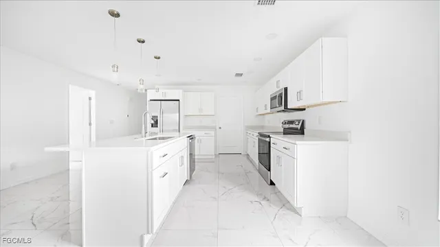 an empty room with a ceiling fan and a window