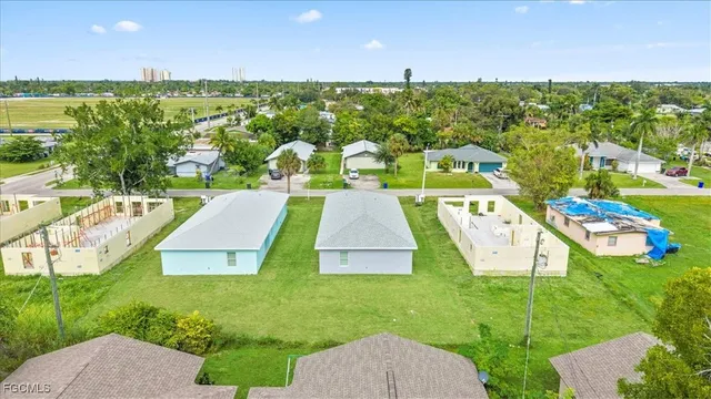 an aerial view of a house with a garden and lake view