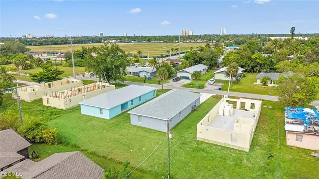 a view of a house with a yard and sitting area