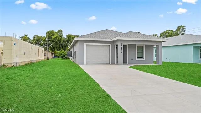a front view of a house with a yard and garage