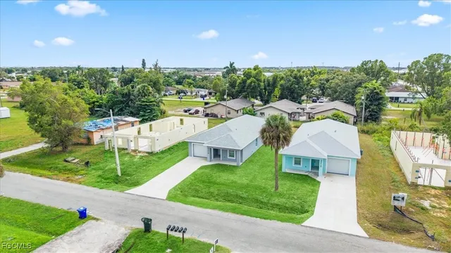 a aerial view of a house with yard swimming pool and outdoor seating