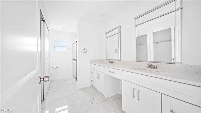 a spacious bathroom with a granite countertop sink mirror and a