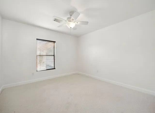 a view of a livingroom with a projector & cabinets