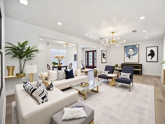 a living room with furniture and a chandelier