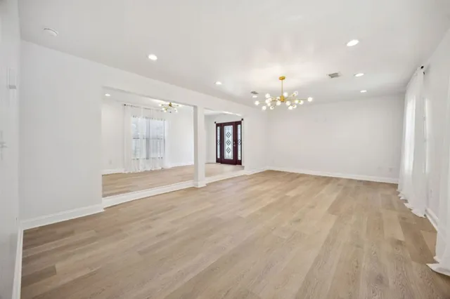 a kitchen with a table chairs refrigerator and microwave