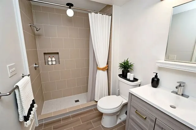 a bathroom with a toilet sink and mirror