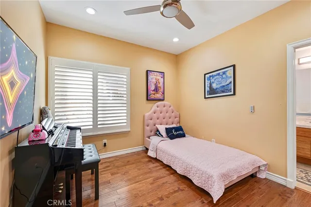 a kitchen with stainless steel appliances granite countertop a sink a stove and a wooden floor