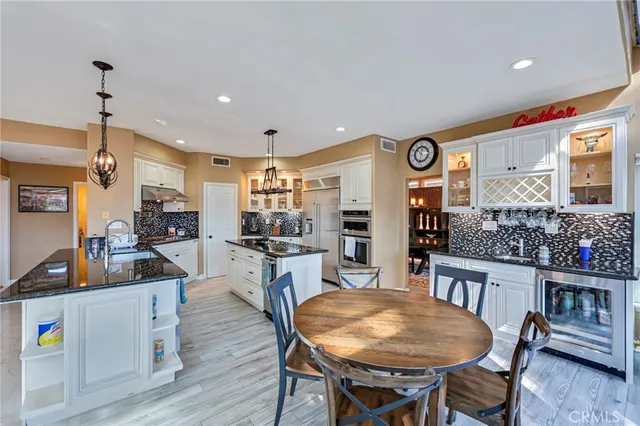 a kitchen with a stove and a wooden floor
