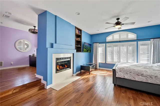 a bathroom with a sink a toilet a mirror and shower
