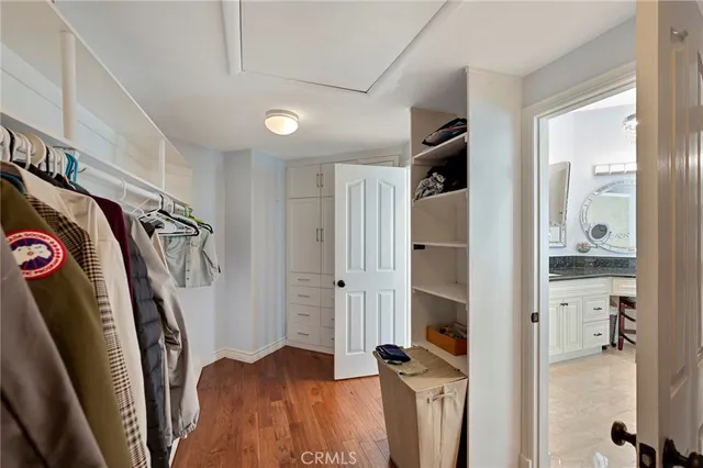 a view of a kitchen with kitchen island stainless steel appliances a table and chairs in it