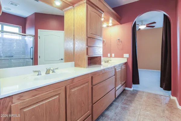 a spacious bathroom with a double vanity sink and a mirror