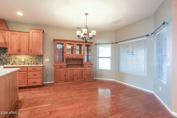 a open kitchen with kitchen island a sink dishwasher a stove and a refrigerator with wooden floor