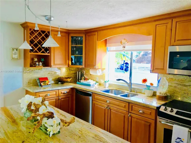 a kitchen with a sink stove and microwave