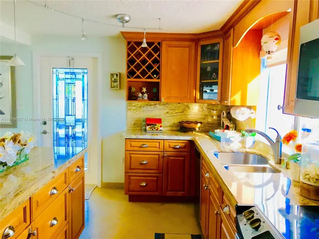 a kitchen with stainless steel appliances a sink and a stove