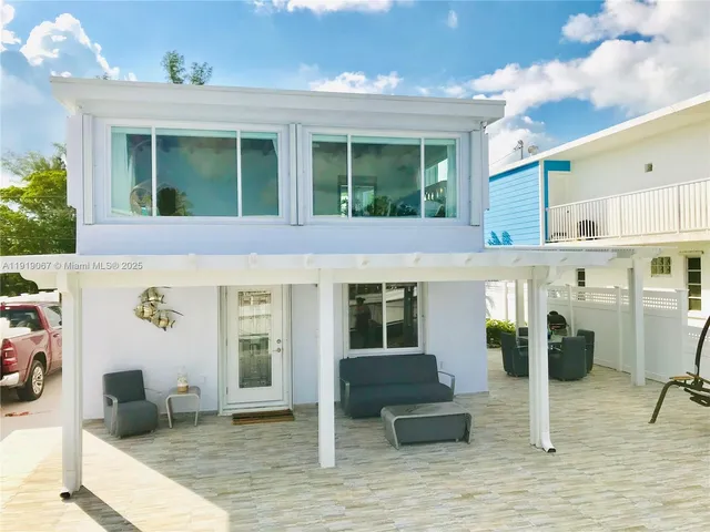 a view of a patio with table and chairs