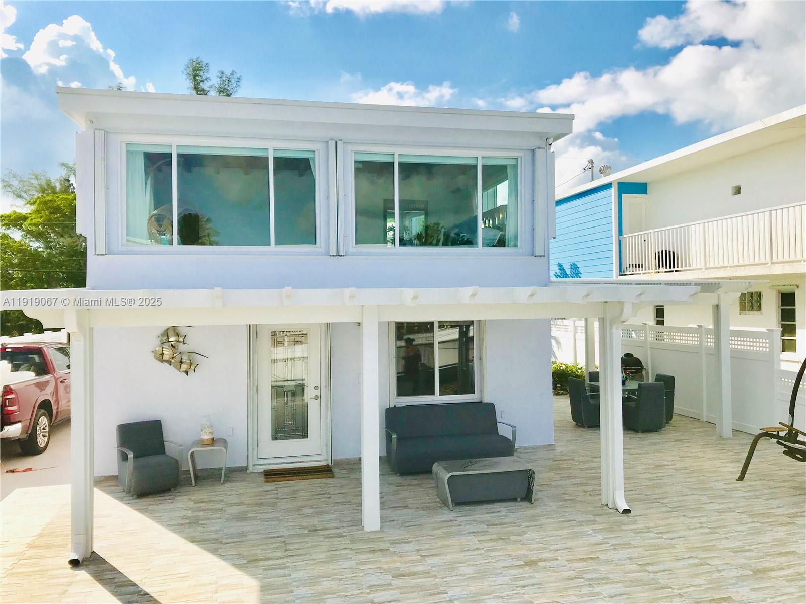 30 Jean Lane Key Largo, FL 33037 - Photo 10 of 17 a view of a patio with table and chairs