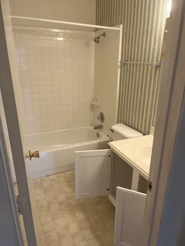 a bathroom with a sink a vanity and shower