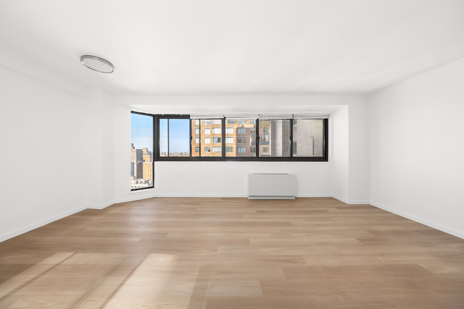 1725 York Avenue, Unit 31H Manhattan, NY 10128 - Photo 4 of 11 a view of an empty room with a window