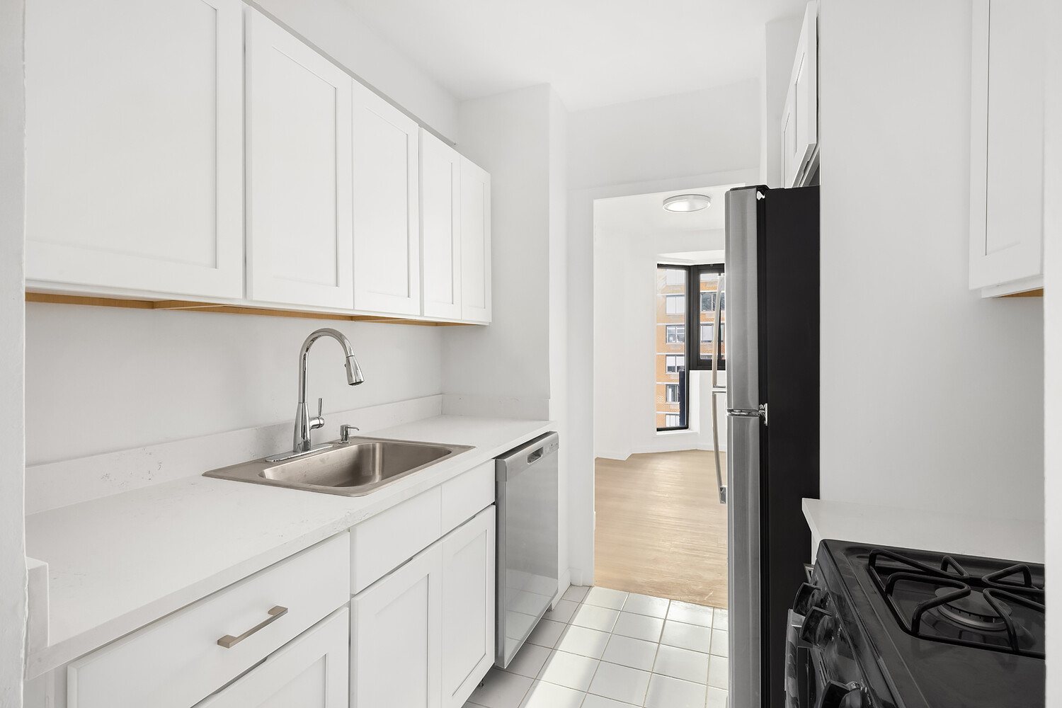 1725 York Avenue, Unit 31H Manhattan, NY 10128 - Photo 5 of 11 a kitchen with a sink and cabinets