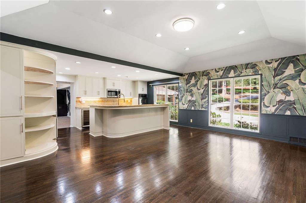 1190 West Wesley Road Northwest Atlanta, GA 30327 - Photo 14 of 46 a large white kitchen with wooden floors and a fireplace