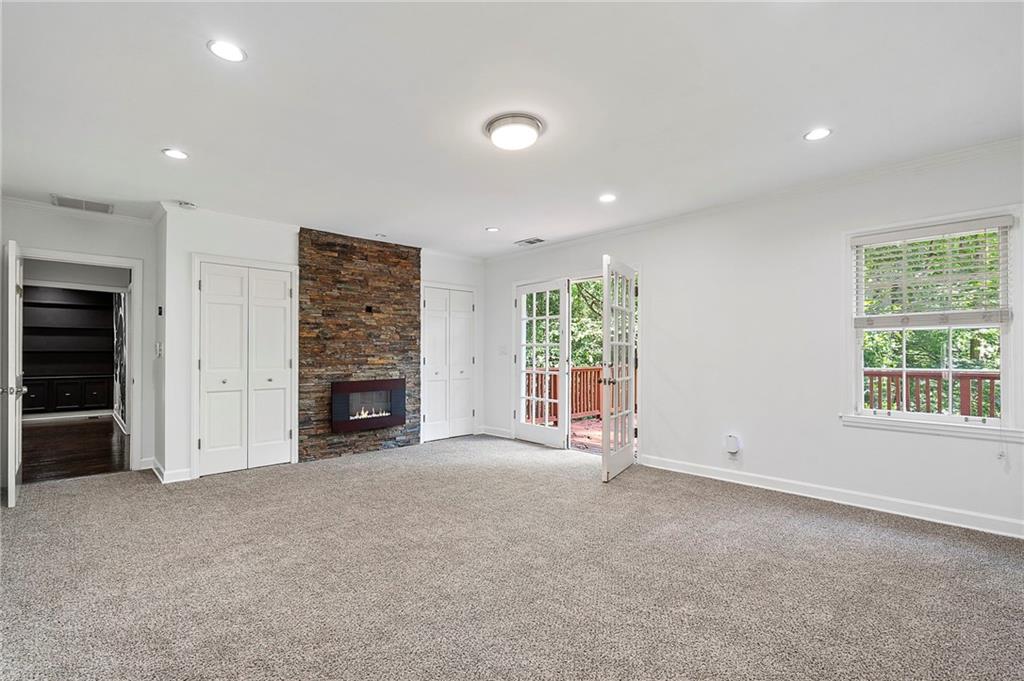 1190 West Wesley Road Northwest Atlanta, GA 30327 - Photo 19 of 46 an empty room with windows and fireplace