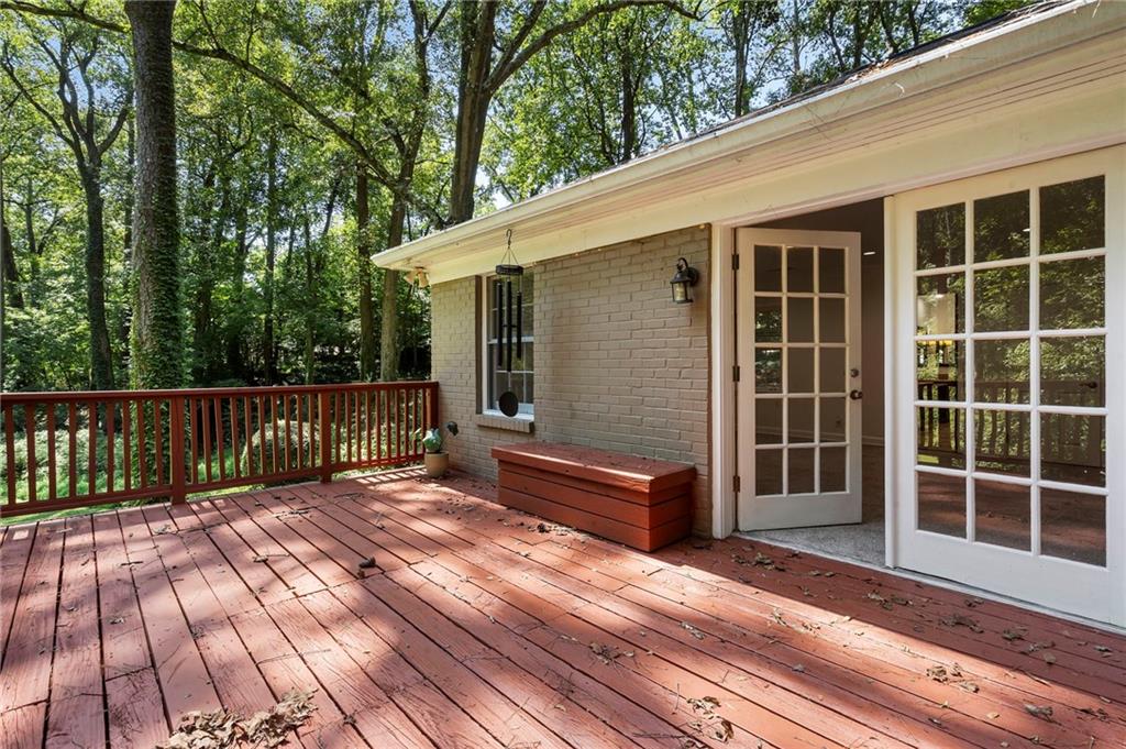 1190 West Wesley Road Northwest Atlanta, GA 30327 - Photo 20 of 46 a view of a deck with wooden floor and fence next to a yard