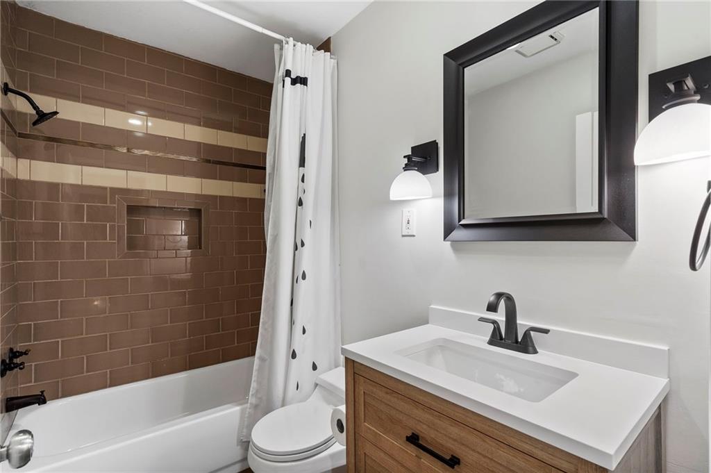 1190 West Wesley Road Northwest Atlanta, GA 30327 - Photo 28 of 46 a bathroom with a sink a toilet and shower