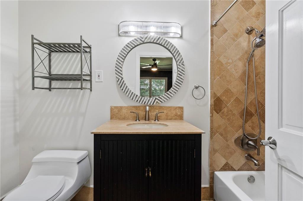 1190 West Wesley Road Northwest Atlanta, GA 30327 - Photo 30 of 46 a bathroom with a sink a toilet and shower