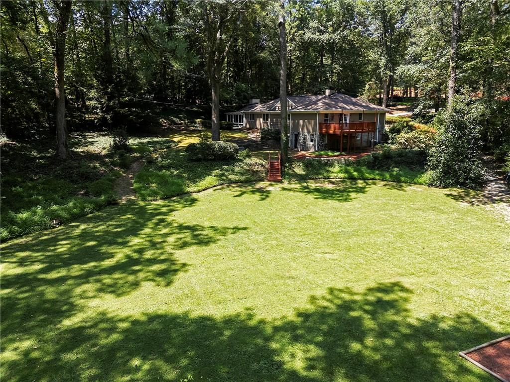 1190 West Wesley Road Northwest Atlanta, GA 30327 - Photo 3 of 46 a view of swimming pool with lawn chairs and plants
