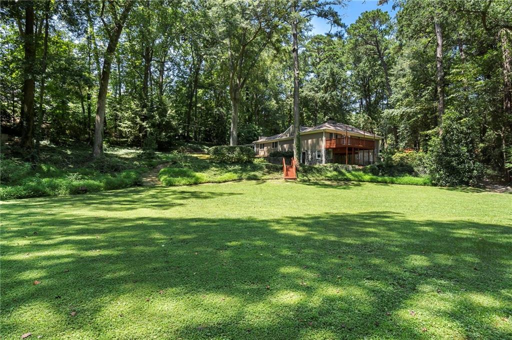 1190 West Wesley Road Northwest Atlanta, GA 30327 - Photo 42 of 46 a view of a house with a backyard porch and sitting area