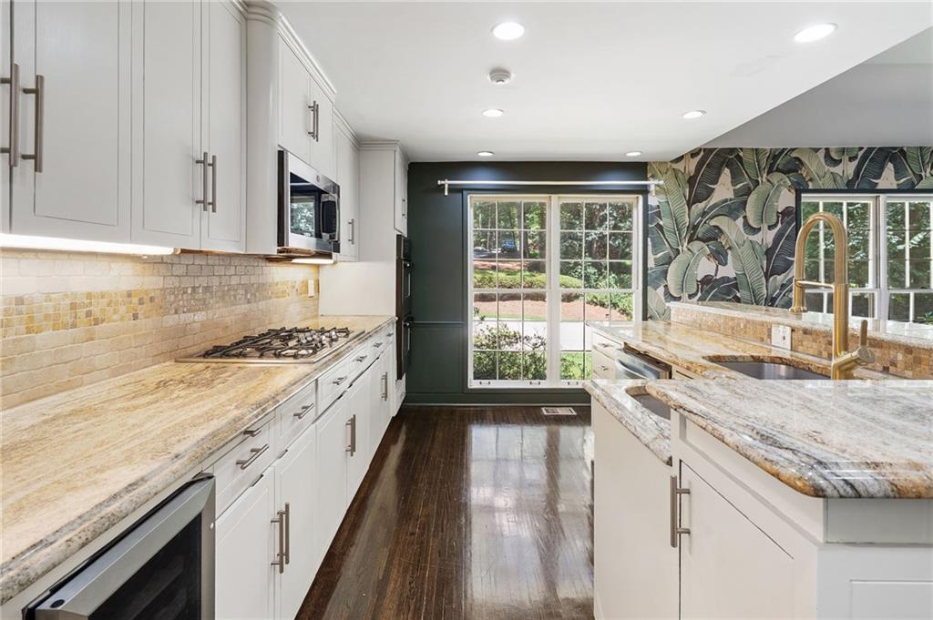1190 West Wesley Road Northwest Atlanta, GA 30327 - Photo 9 of 46 a kitchen with a sink stove and cabinets