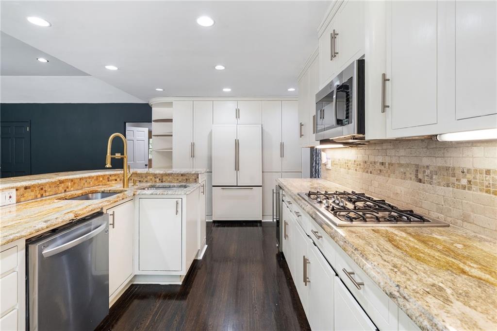 1190 West Wesley Road Northwest Atlanta, GA 30327 - Photo 10 of 46 a kitchen with kitchen island granite countertop stainless steel appliances a sink stove top oven and cabinets