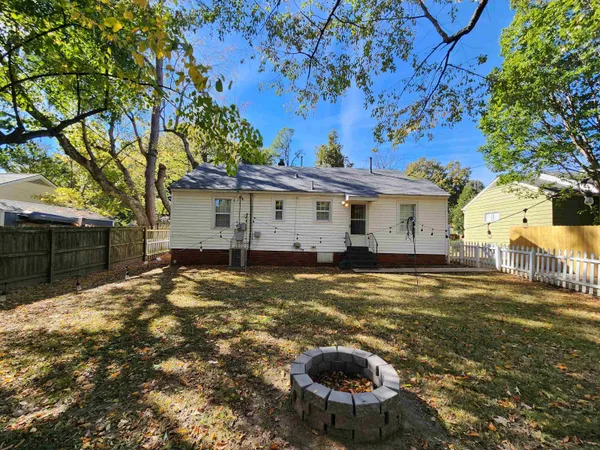 a backyard of a house with table and chairs
