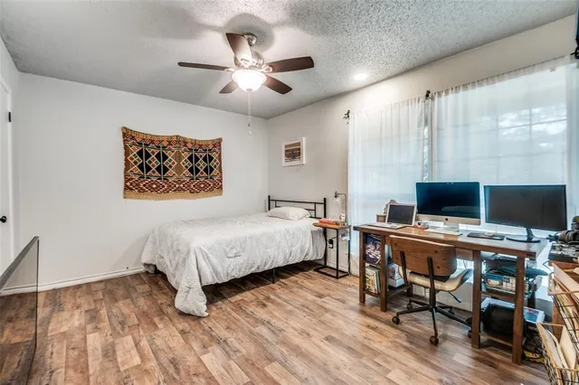 a bedroom with a bed and a computer on a table
