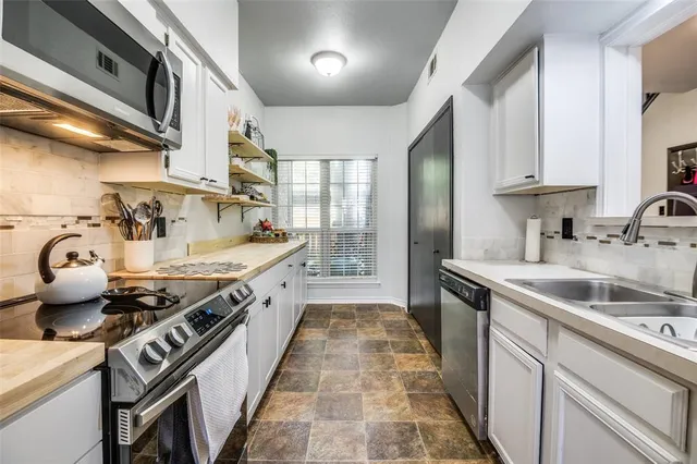 a kitchen with a stove and a sink
