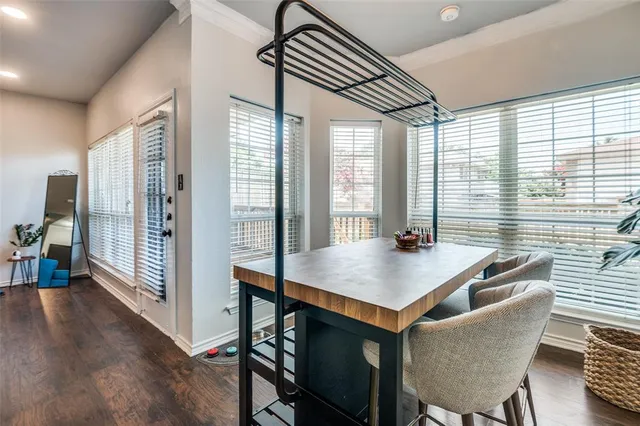 a kitchen with a table chairs and wooden floor