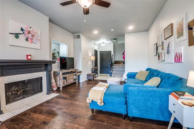 a living room with furniture kitchen view and a fireplace