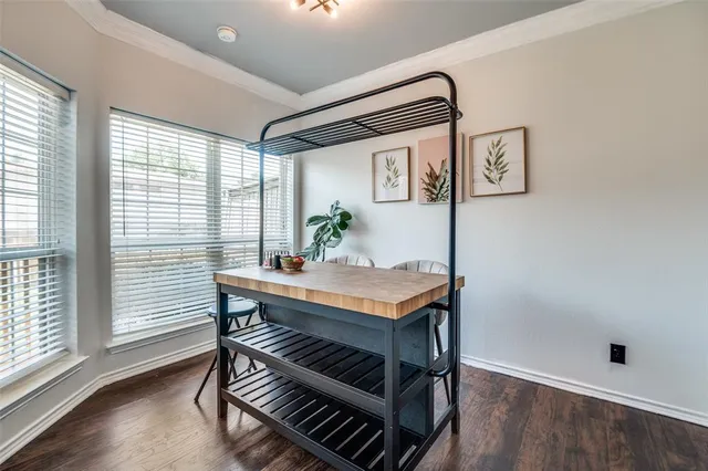 a view of a workspace with furniture and wooden floor