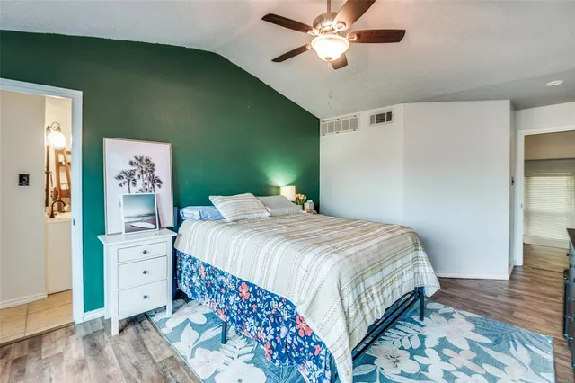a bedroom with a large bed and a chandelier