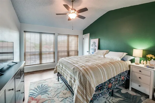 a bedroom with a bed and a large window