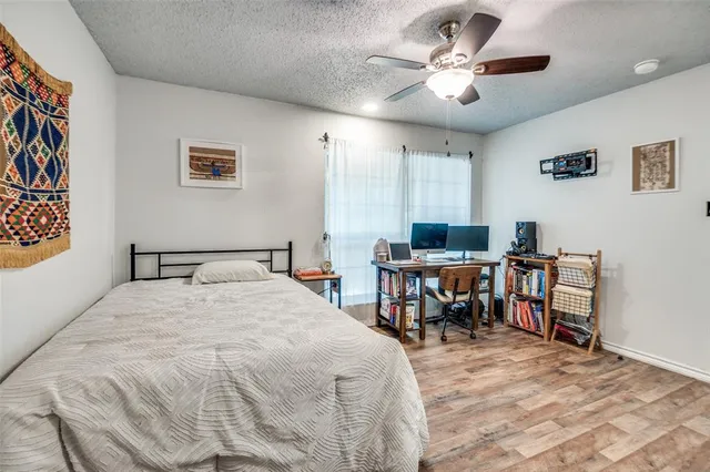 a bed room with a bed and a chair