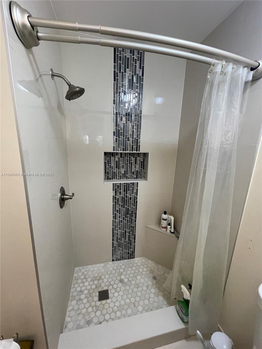 a bathroom with a shower and a toilet