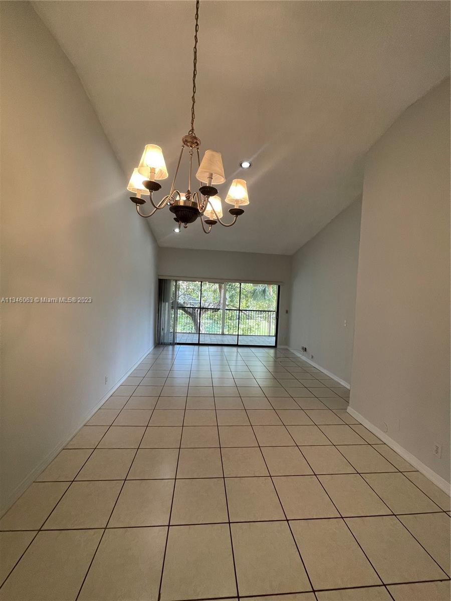 2201 Southwest 15th Street, Unit 252 Deerfield Beach, FL 33442 - Photo 12 of 12 a view of a livingroom with a chandelier fan and window