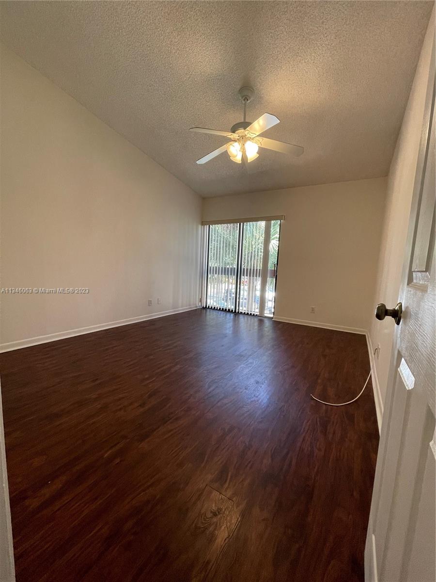 2201 Southwest 15th Street, Unit 252 Deerfield Beach, FL 33442 - Photo 8 of 12 wooden floor in an empty room with a window