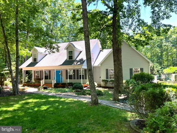 a front view of a house with a yard table and chairs